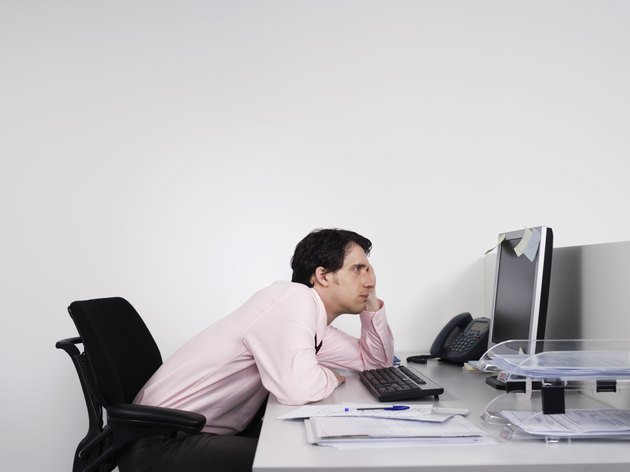 Bored Male Office Worker At Desk