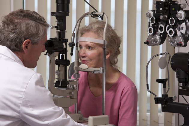 Ophthalmologist examining a woman's eyes with a slit lamp