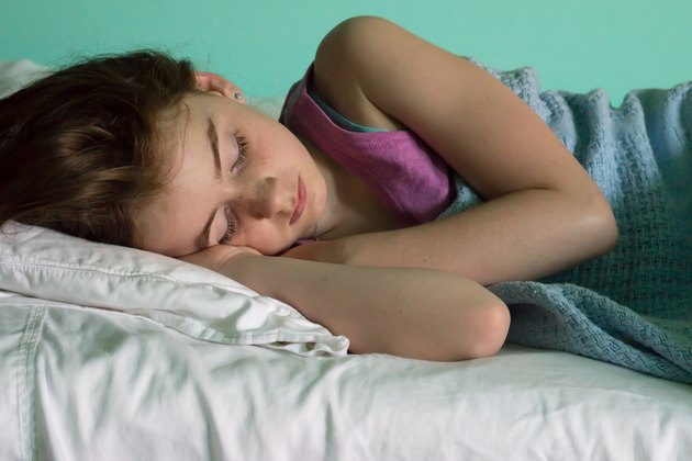 Young girl sleeping peacefully in bed