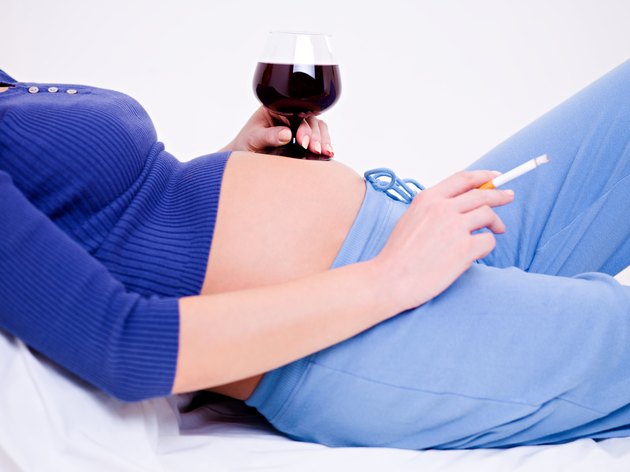 Pregnant woman with a glass of wine