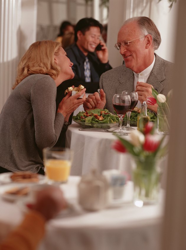 Mature couple sitting in restaurant, talking