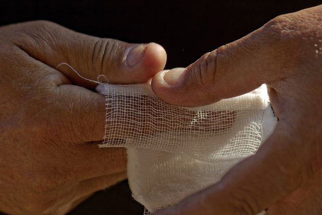 White medicine bandage on human injury hand finger