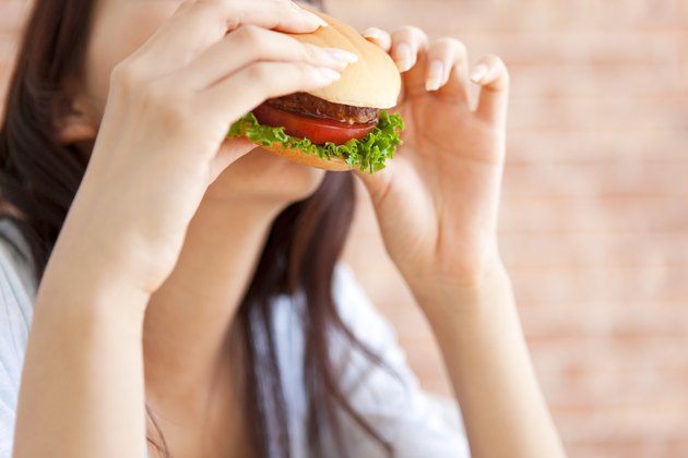 Young woman eating a hamburger