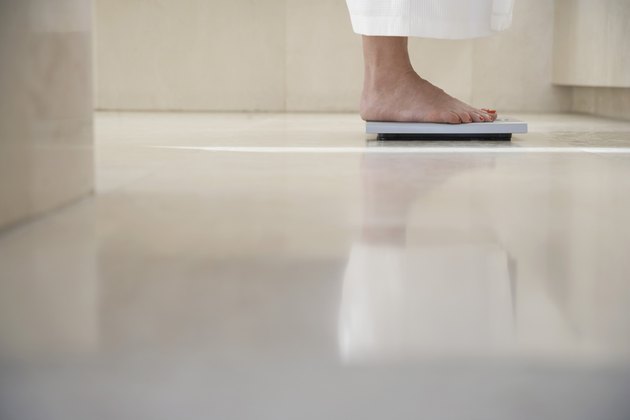 Woman Standing On Weighing Scale