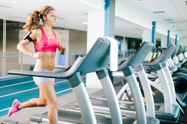 Young woman running on treadmill