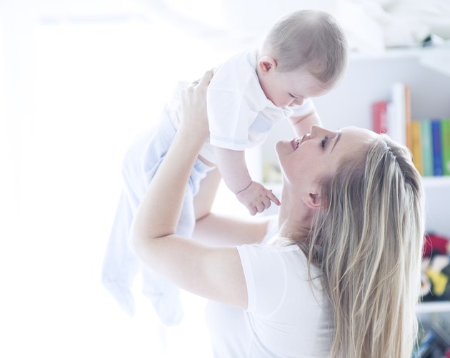 Teenage girl holding baby boy