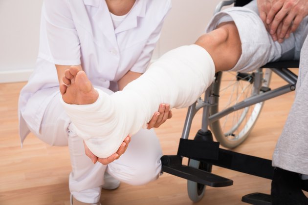 Female Doctor Holding Patient's Leg