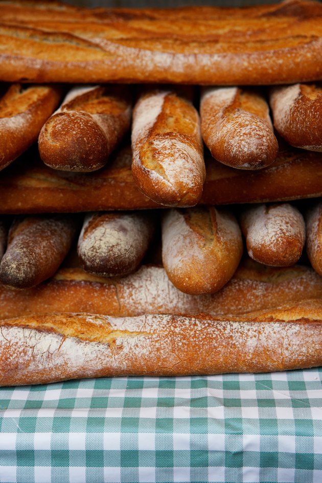 Baguettes stacked together on market stall, close-up