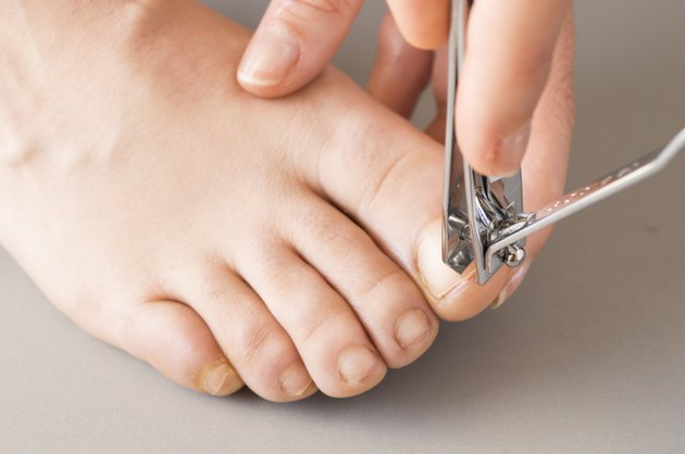 woman making herself a pedicure