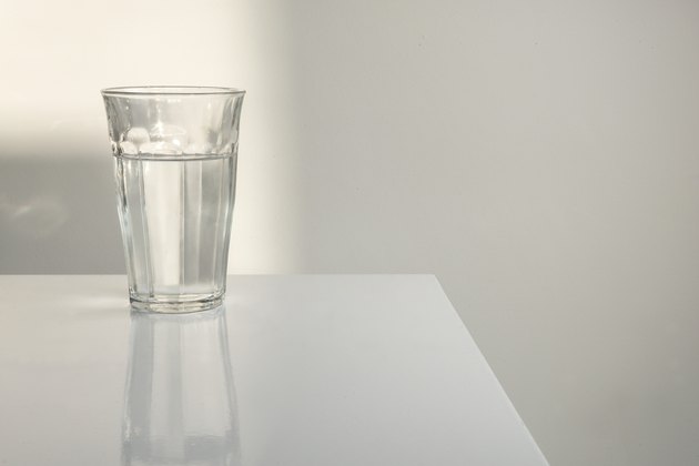 Glass of water on white table