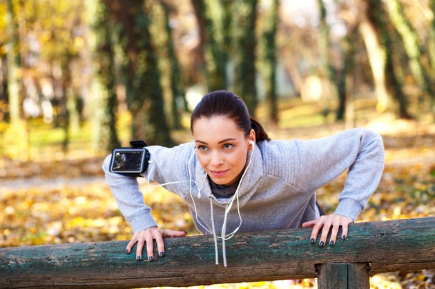 Sporty woman doing push-ups in the park