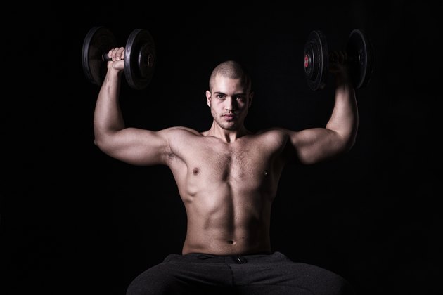Muscular men exercising with weights