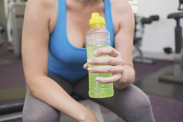 Fit brunette drinking energy drink
