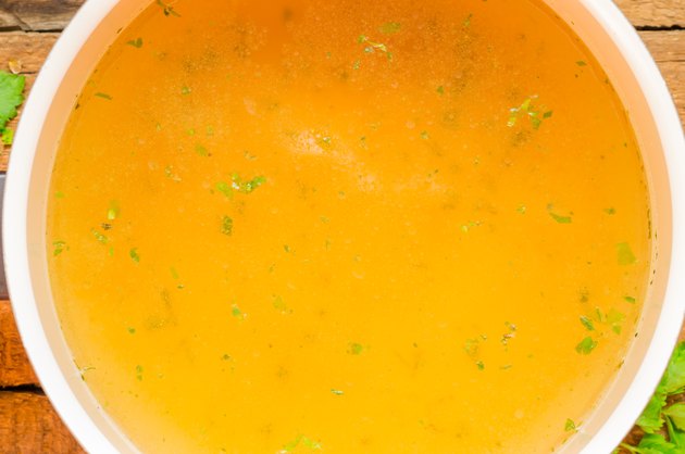 Closeup of broth, clear soup or bouillon in a saucepan