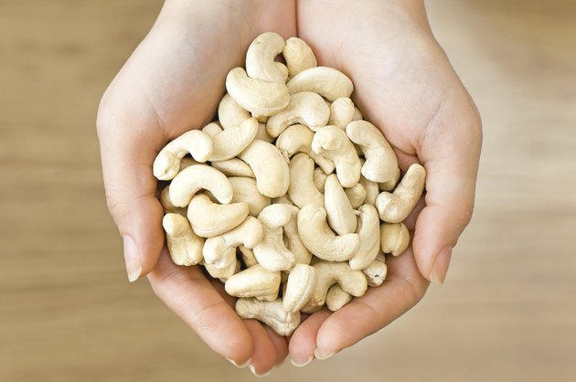 Cashew nuts in woman's hands