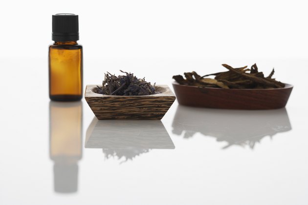 Bottle of aromatherapy oil, dried lavender and Chinese skullcap