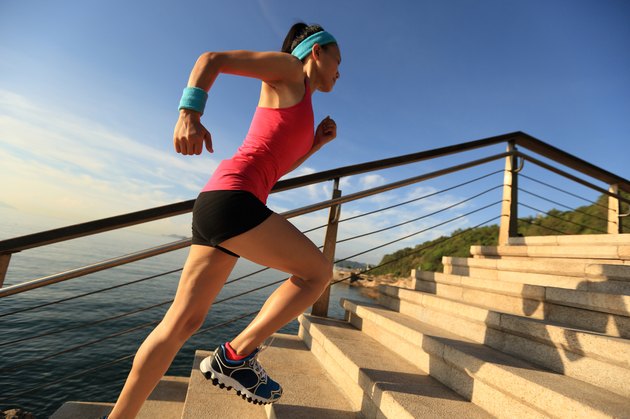 healthy lifestyle sports woman running up on stone stairs seaside