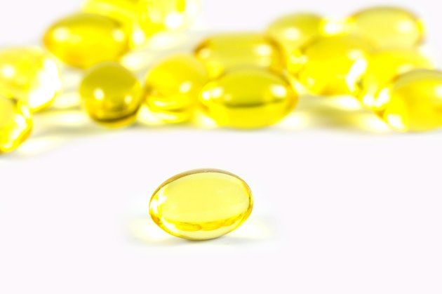 Rice bran oil pills on white background