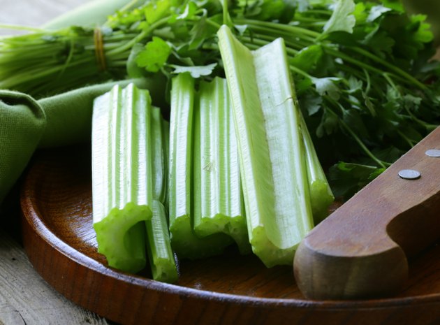 fresh celery sticks on a wooden table