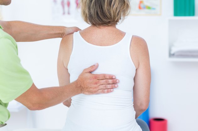Doctor examining his patient back