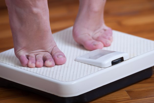 Womans feet and time for weight truth from a scale