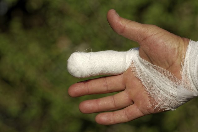 White medicine bandage on human injury hand finger