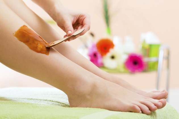 Woman in Spa getting leg waxed for hair removal