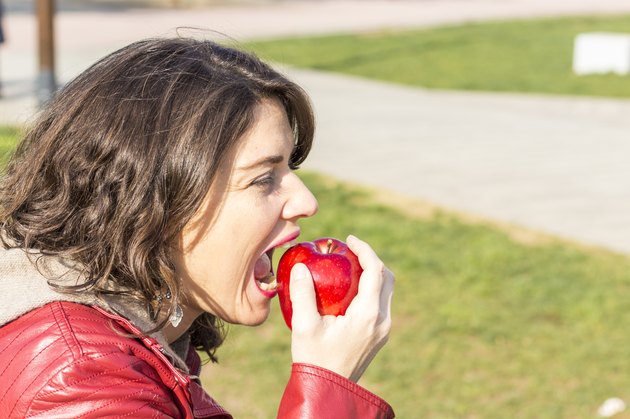 Woman biting an apple