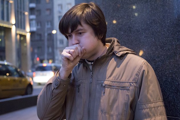 Young ill man coughing