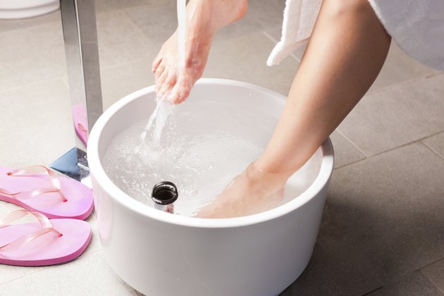 Woman having hydrotherapy water footbath
