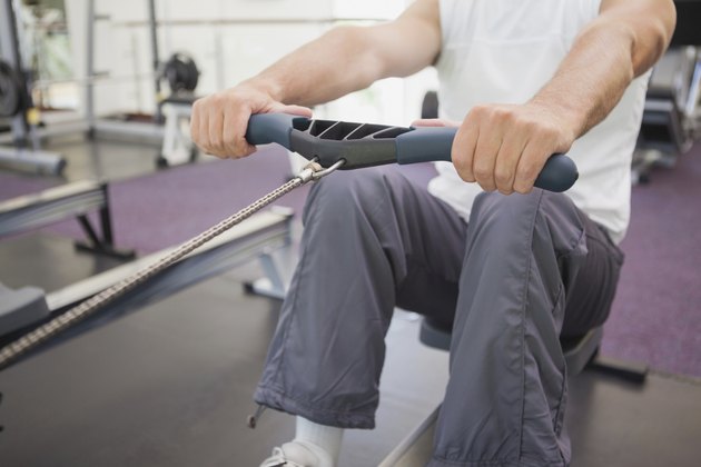Fit man working out on rowing machine