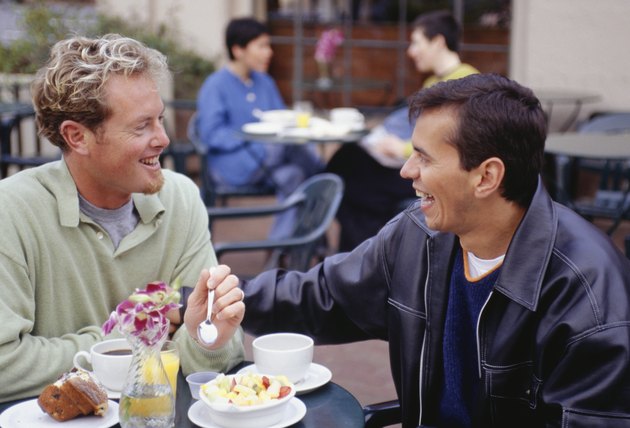 Men eating breakfast at outdoor cafe