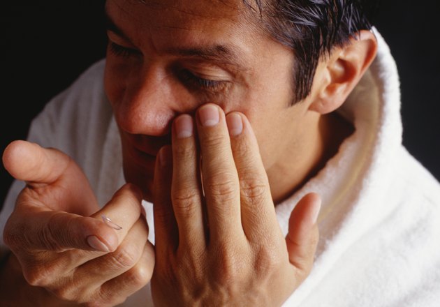 Man inserting contact lenses, close-up