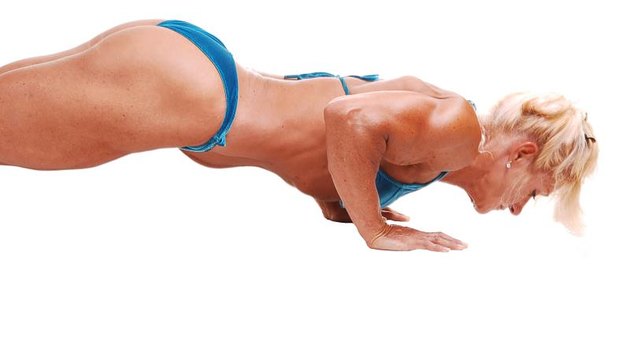 Woman doing pushups.