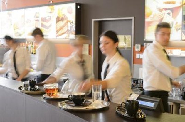 Busy waiter and waitresses working at bar night