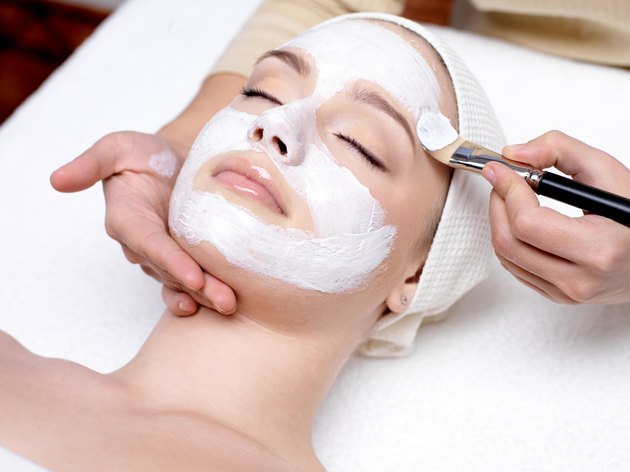 Woman having facial mask at beauty salon