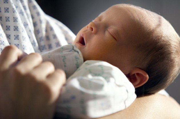 close up of a caucasin newborn in its mothers arm