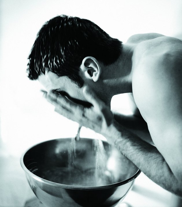 Man splashing face