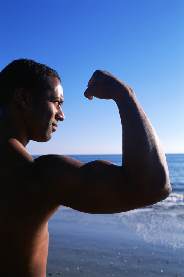Man flexing near coast
