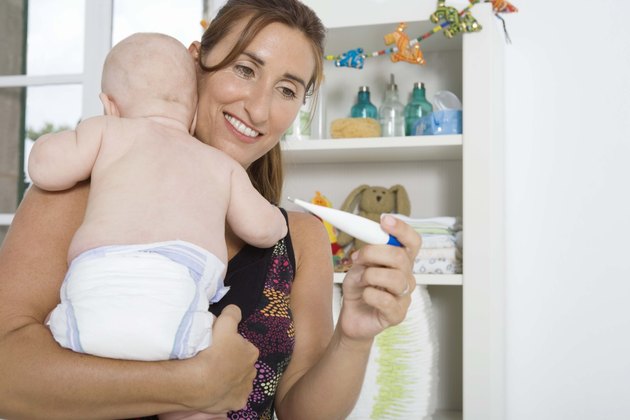 Mother checking temperature of baby