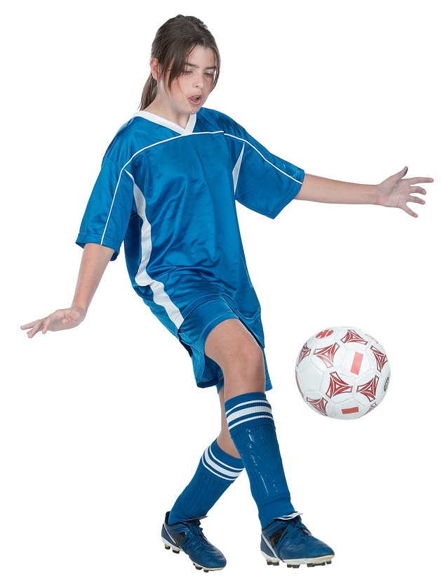 Girl kicking soccer ball