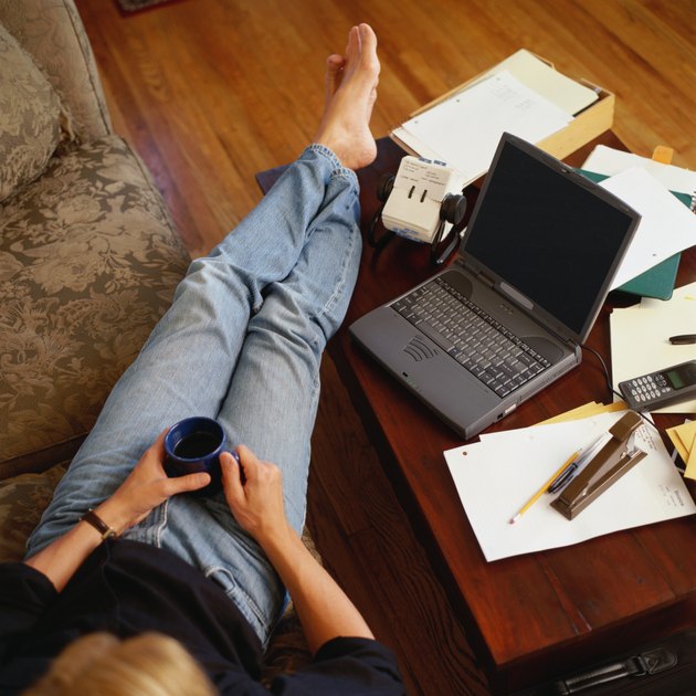 Man Relaxing on Couch with Laptop