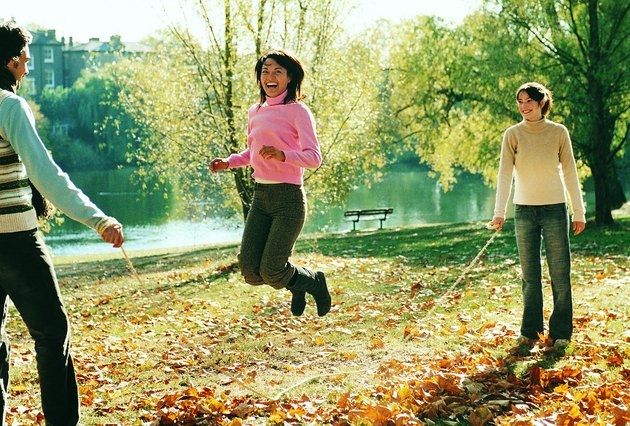 Young Man and Woman Holding a Skipping Rope in a Park and a Portrait of a Young Woman Skipping