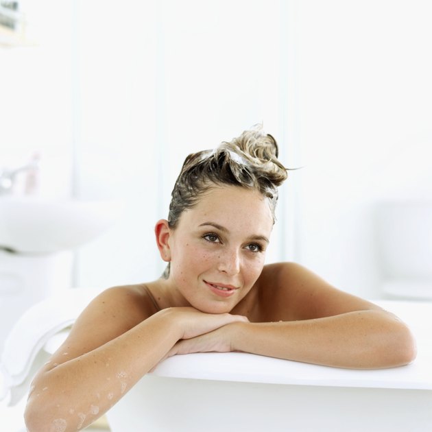 Portrait of a young woman sitting in a bathtub