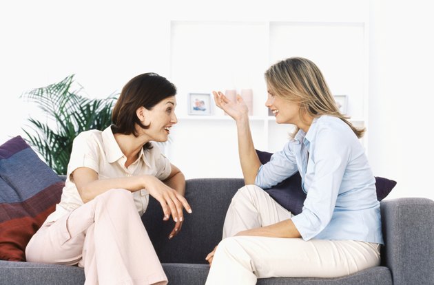 Two women talking in living room
