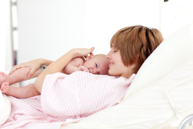 Mother embracing her newborn baby