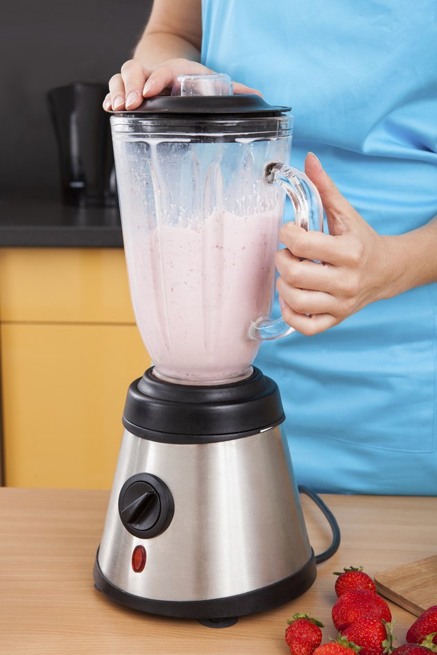 Woman Making Strawberry Milkshake