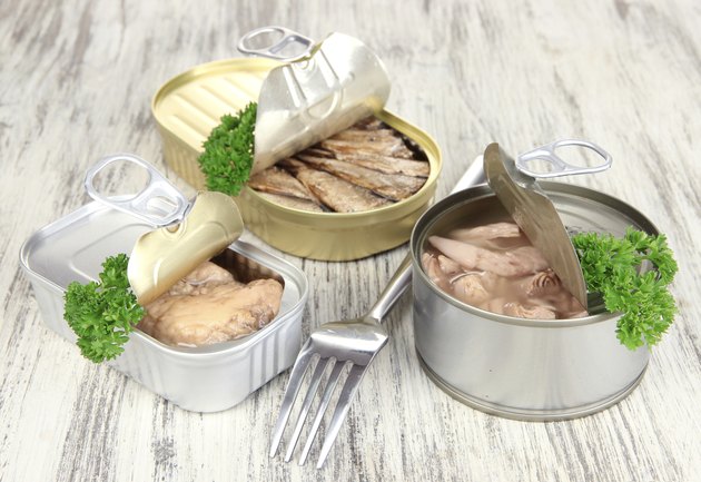 Open tin can, on wooden background