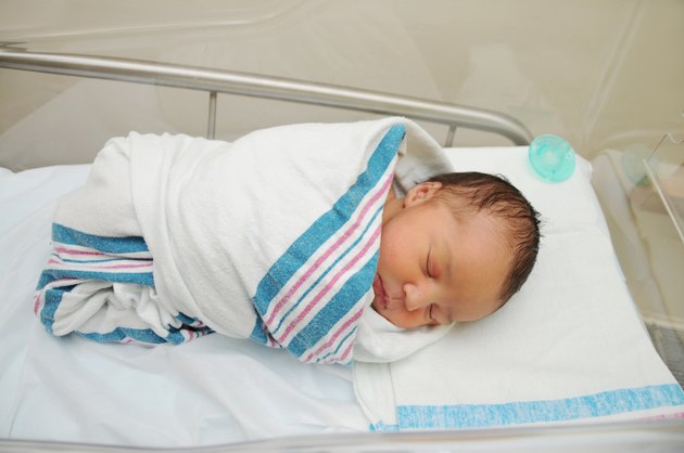 Sleeping Newborn Infant in Hospital Bassinet