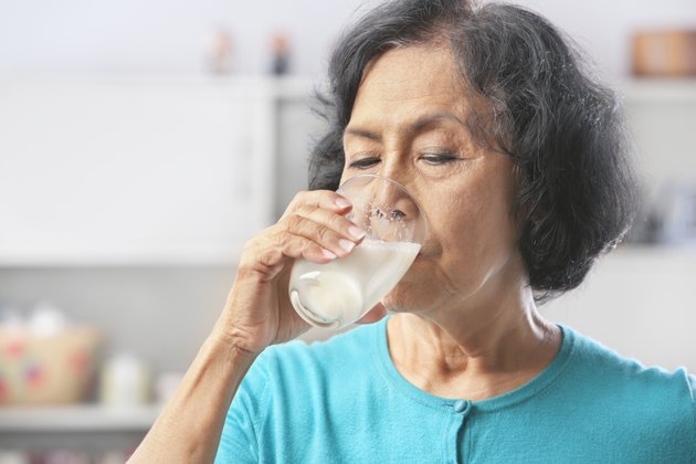 Senior woman drinking milk